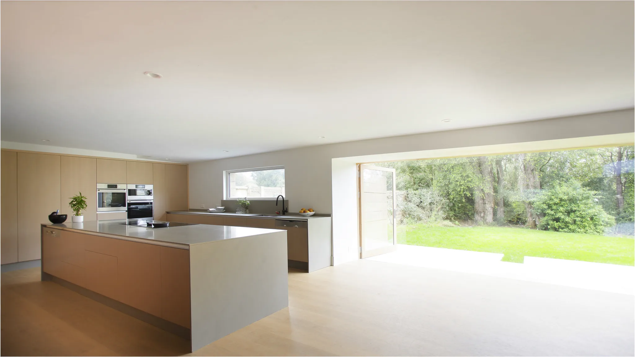 An established family home with a paved patio and a wide lawn